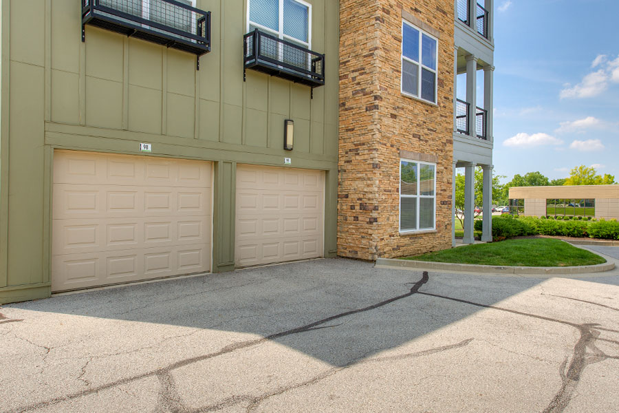 Exterior view of the garages tucked underneath the upper level apartments.