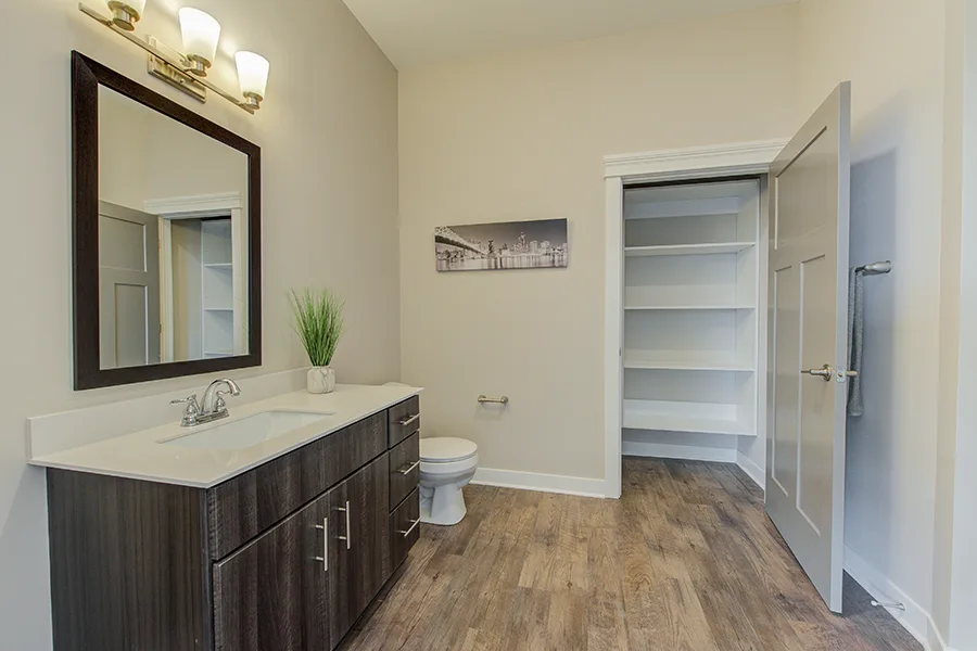 A spacious bathroom and closet at Penrose on Mass Apartments